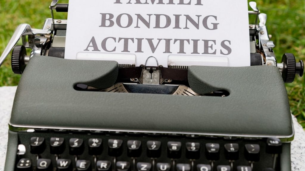 a typewriter with a family bonding activities sign on it
